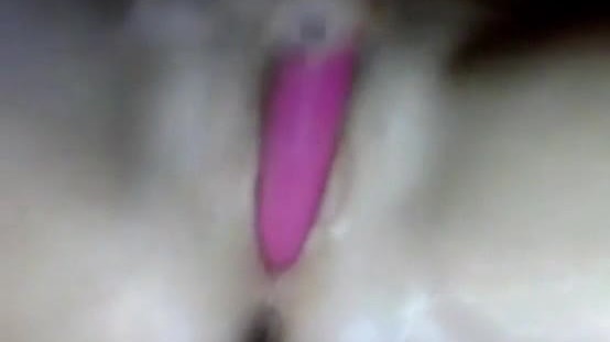 Bored girl plays with a pink dildo